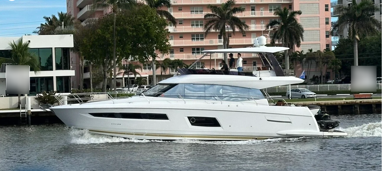 Boca Raton yacht charter cruising past waterfront buildings.