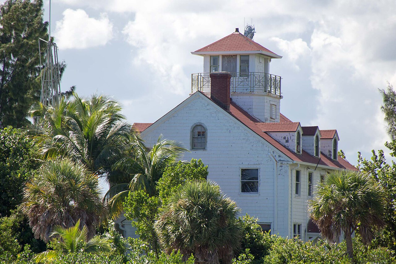 Historic Detachment Hotel building with red roof and palms.