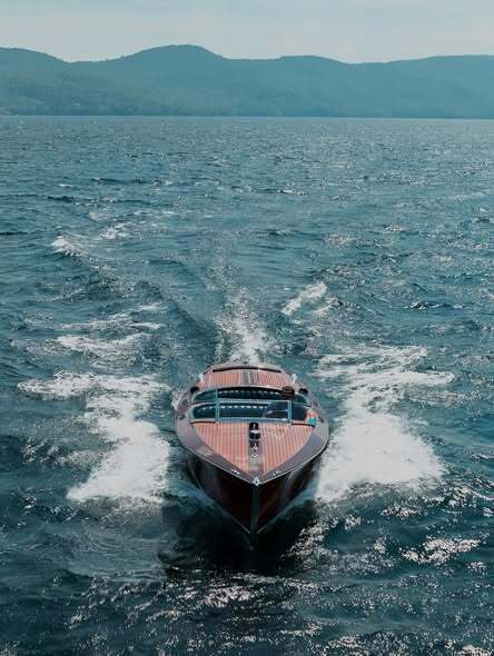 Luxury wooden motorboat cruising Fort Lauderdale waters swiftly.