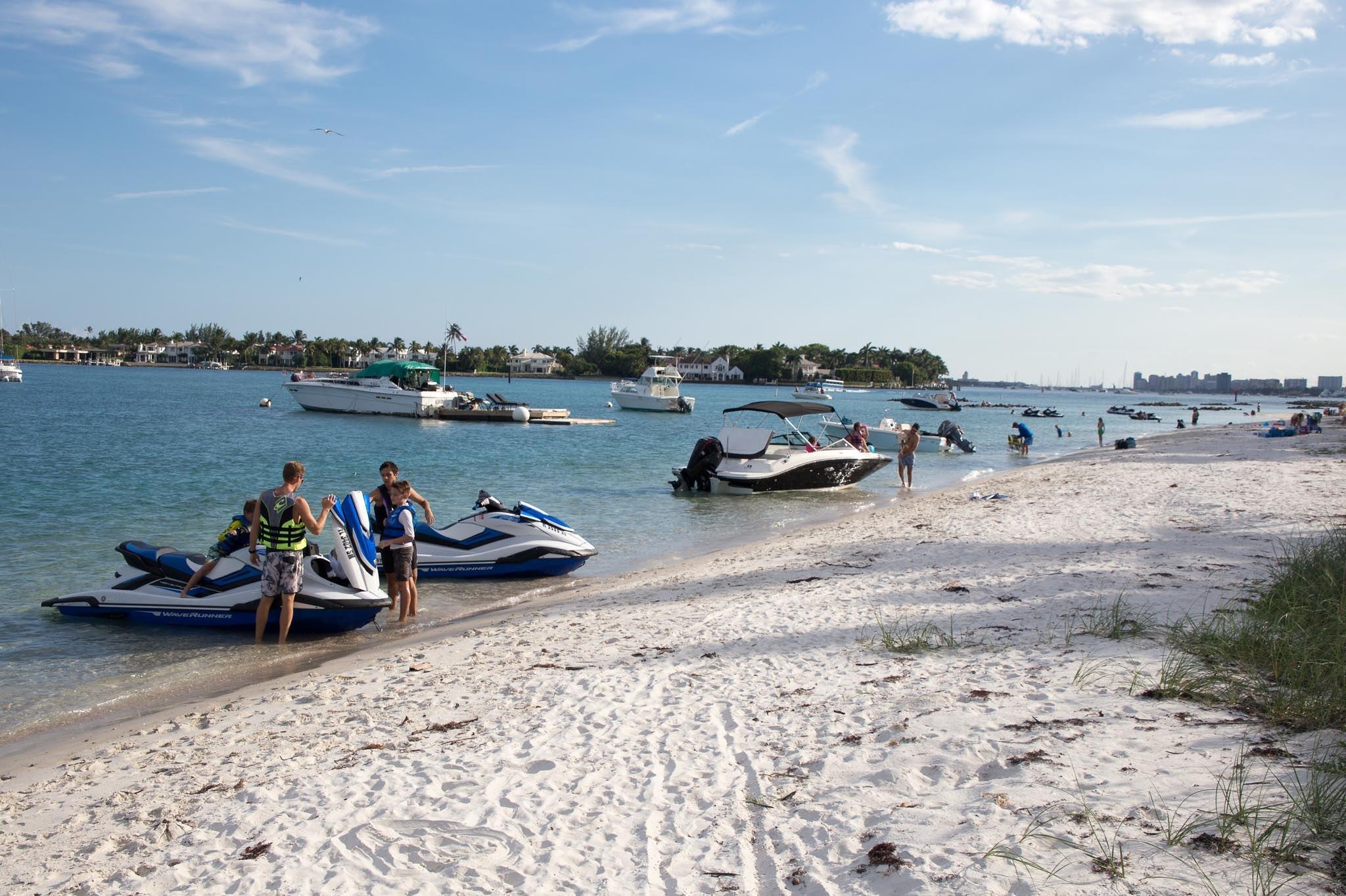 Peanut Island beach with boats, jet skis, and swimmers