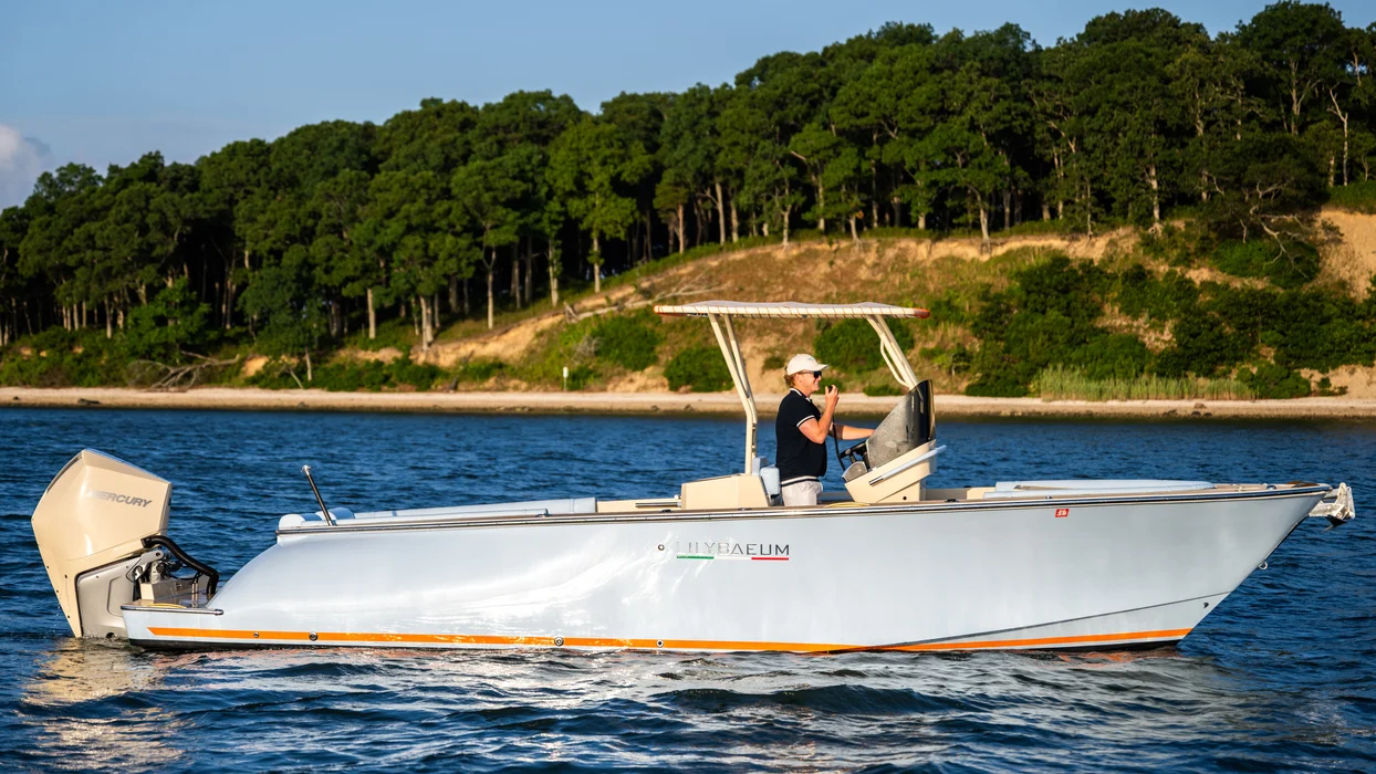 Private motorboat cruising calm Intracoastal waters near shoreline.