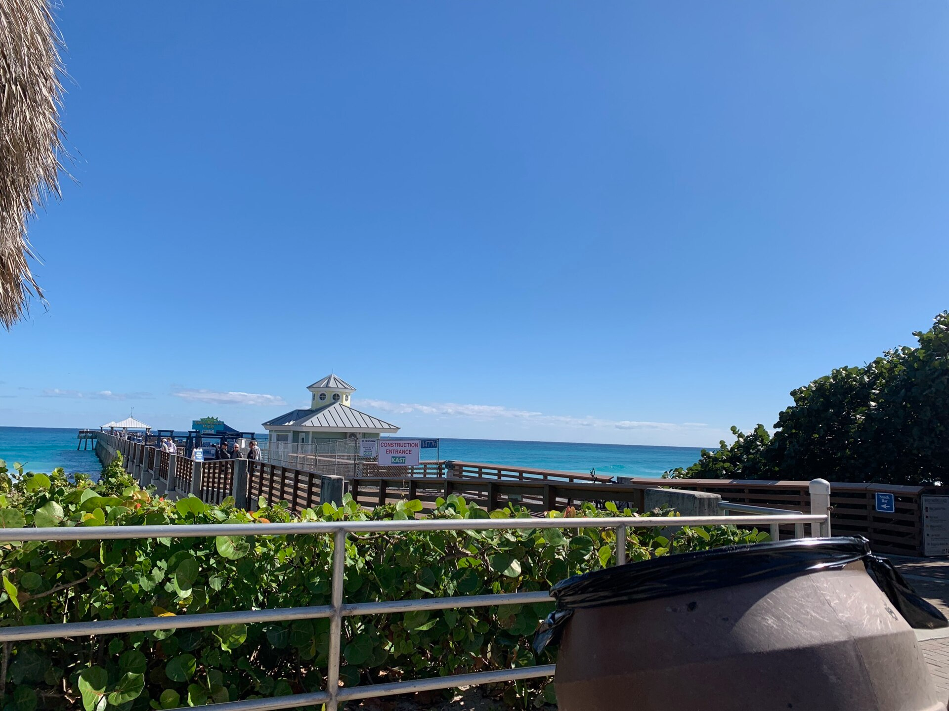 Juno Beach Park pier extending over turquoise ocean water.
