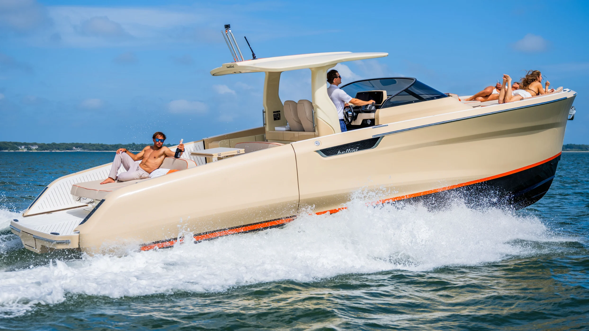 Luxury motorboat cruising with people relaxing under sunny sky.