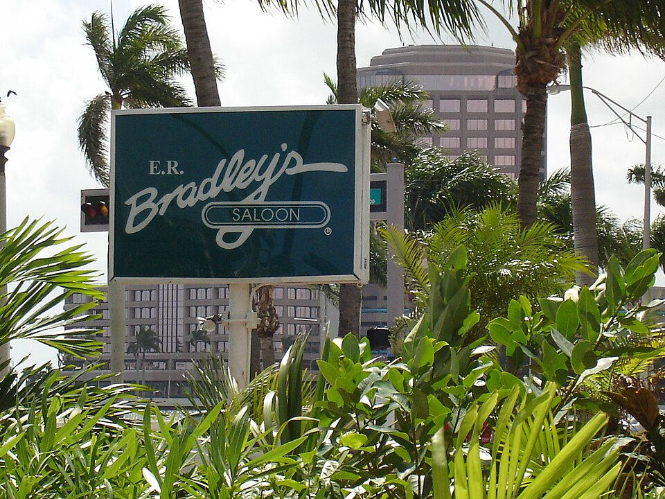 E.R. Bradley’s Saloon sign surrounded by palm trees.